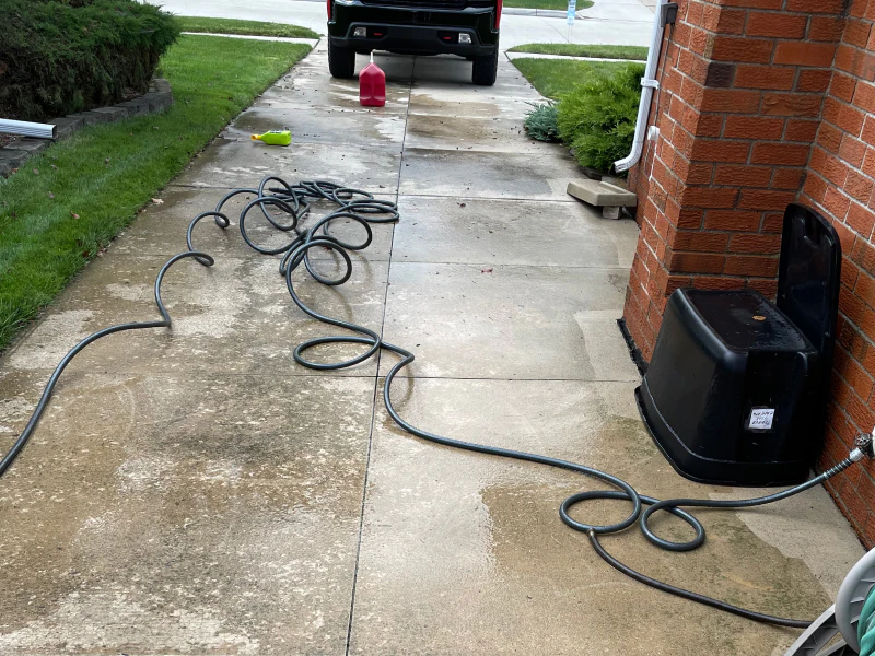 hose outside a house during a concrete washing washington mi