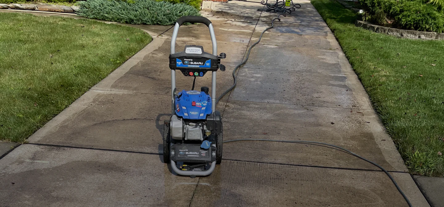 machine working on a driveway washing washington mi